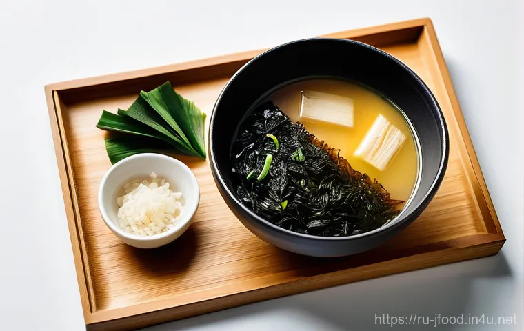 일본식 된장국 만드는 법 - **A comforting bowl of Miso soup, captured in a warm and inviting light.**
    The soup is presented...